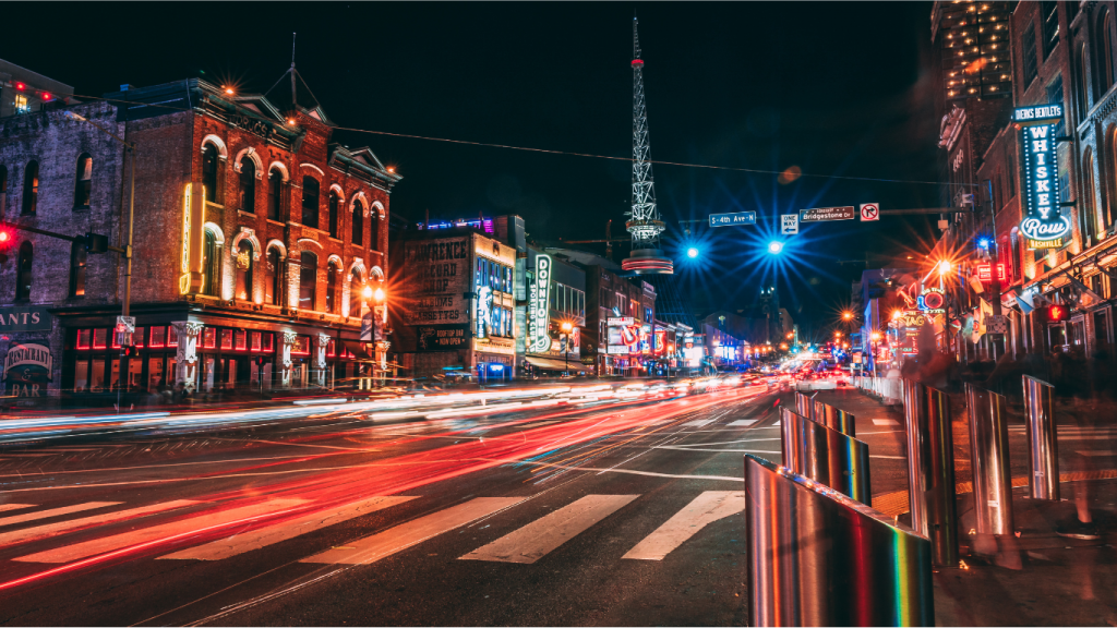 Downtown Nashville Broadway corridor at night representing retail real estate growth and market demand